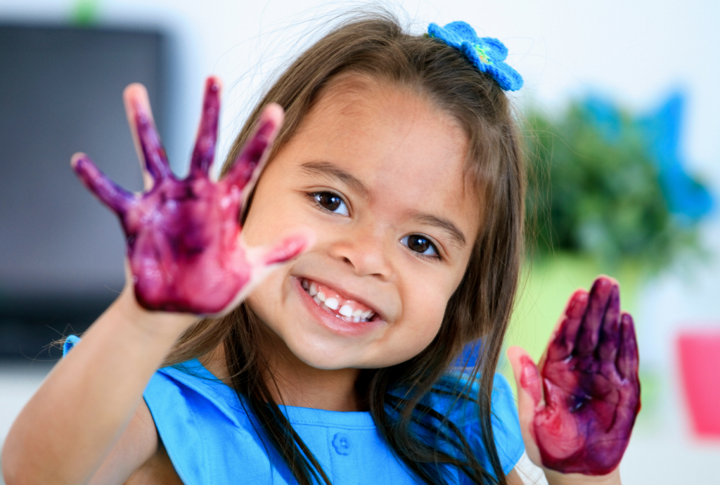 child painting with hands