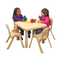 children sitting at large tan square value table