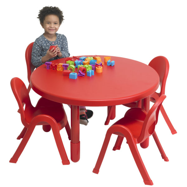 child sitting at red round value table