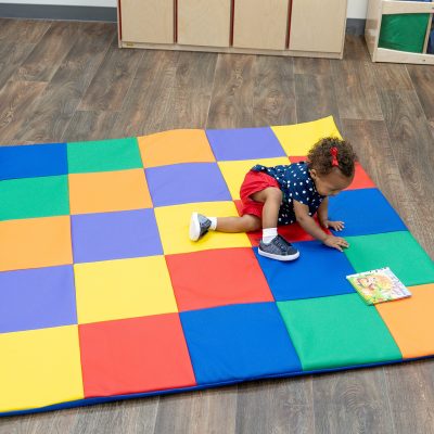 Child Crawling on Patchwork Mat
