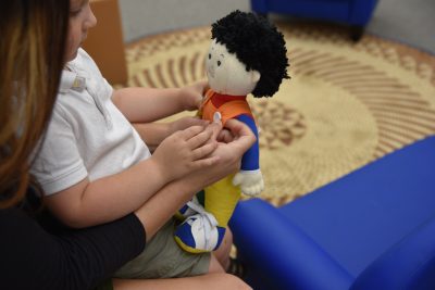 Parent uses Learn to Dress Doll with Child - Walk a mile in my Velcro shoes